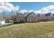 Charming brick home featuring a well-manicured lawn, dormer windows, and a covered side porch at 304 Wintergreen Ct, Kings Mountain, NC 28086
