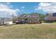 Inviting single-story brick home with a lush front yard and mature landscaping at 304 Wintergreen Ct, Kings Mountain, NC 28086