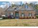 Charming brick and stone home with a well-manicured lawn and colorful landscaping in a suburban setting at 304 Wintergreen Ct, Kings Mountain, NC 28086