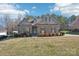 Charming single-story home featuring a brick facade, dormer windows and mature landscaping at 304 Wintergreen Ct, Kings Mountain, NC 28086