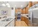 This home features stainless steel appliances, granite countertops, and custom wood cabinetry at 304 Wintergreen Ct, Kings Mountain, NC 28086