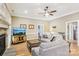 Relaxing living room with a ceiling fan, hardwood floors, and a decorative fireplace at 304 Wintergreen Ct, Kings Mountain, NC 28086