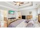 Bright main bedroom has a tray ceiling, ceiling fan, and an ensuite bathroom entrance at 304 Wintergreen Ct, Kings Mountain, NC 28086