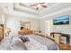 Bright main bedroom features a tray ceiling, ceiling fan, and a mounted television at 304 Wintergreen Ct, Kings Mountain, NC 28086