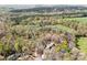 Expansive aerial shot showcasing the home's placement on a large, wooded lot with mature trees providing seclusion at 3249 Ivey Creek Rd, Maiden, NC 28650