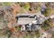 Aerial view of home, surrounded by mature trees, a wrap-around driveway and lush landscaping at 3249 Ivey Creek Rd, Maiden, NC 28650
