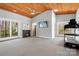 Cozy bonus room featuring a wooden ceiling, fireplace, and fitness equipment at 3249 Ivey Creek Rd, Maiden, NC 28650