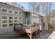 Home's exterior, showcasing large windows that offer plenty of natural light, with a deck and lower level garage at 3249 Ivey Creek Rd, Maiden, NC 28650