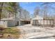 View of the property and its unique features, showing a garage, pergola, and stone accents in a modern setting at 3249 Ivey Creek Rd, Maiden, NC 28650