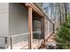 View of an exterior porch with wooden railing and an outdoor air conditioning unit at 3249 Ivey Creek Rd, Maiden, NC 28650