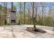Outdoor stone fireplace and fountain on a spacious stone backyard patio at 3249 Ivey Creek Rd, Maiden, NC 28650