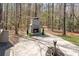 Backyard stone patio with an outdoor stone fireplace, and fountain at 3249 Ivey Creek Rd, Maiden, NC 28650