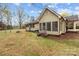 The back of the house shows a screened-in porch and large, grassy yard surrounded by trees at 325 Hurley School Rd, Salisbury, NC 28147
