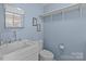 Cozy bathroom with a pedestal sink, toilet, and a mirrored medicine cabinet above the sink at 325 Hurley School Rd, Salisbury, NC 28147