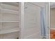 Bathroom featuring a bathtub with shower, and shelving storage with an open door to hardwood flooring at 325 Hurley School Rd, Salisbury, NC 28147