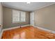 Bedroom with neutral walls, hardwood flooring, and a bright window for natural light at 325 Hurley School Rd, Salisbury, NC 28147