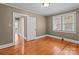Another view of a bedroom showcasing hardwood flooring, a window, and a classic door frame at 325 Hurley School Rd, Salisbury, NC 28147