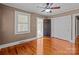 Cozy bedroom with hardwood floors, ceiling fan, and natural light from windows at 325 Hurley School Rd, Salisbury, NC 28147