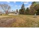 Charming yellow home featuring a fenced yard and a well-maintained lawn in a suburban neighborhood at 325 Hurley School Rd, Salisbury, NC 28147