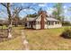 Side view of a cozy home featuring wood siding, a brick chimney, and a well-manicured yard at 325 Hurley School Rd, Salisbury, NC 28147