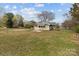 Charming yellow home featuring a fenced yard and a well-maintained lawn in a suburban neighborhood at 325 Hurley School Rd, Salisbury, NC 28147