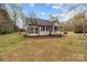 Bungalow-style home with a screened-in porch in a well-maintained yard, set against a blue sky at 325 Hurley School Rd, Salisbury, NC 28147