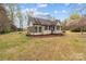 A charming house features a screened-in porch and tidy front yard, showcasing its curb appeal at 325 Hurley School Rd, Salisbury, NC 28147