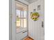 Charming front door with welcoming sunflower wreath and security system view into well-maintained yard at 325 Hurley School Rd, Salisbury, NC 28147
