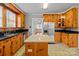 Kitchen featuring stainless appliances, wood cabinets, an island and black countertops at 325 Hurley School Rd, Salisbury, NC 28147