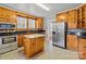Bright kitchen features wooden cabinets, granite counters, stainless appliances and an island at 325 Hurley School Rd, Salisbury, NC 28147