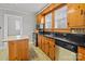 Cozy kitchen features stainless appliances, black countertops and vintage-style wood cabinets at 325 Hurley School Rd, Salisbury, NC 28147
