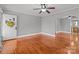 Spacious living room with hardwood floors, decorative archway and charming front door with wreath at 325 Hurley School Rd, Salisbury, NC 28147