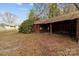 Rustic outbuilding or shed featuring a weathered exterior next to a cozy home at 325 Hurley School Rd, Salisbury, NC 28147