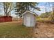 Exterior shot of gray storage shed in backyard with a red shed in the background at 325 Hurley School Rd, Salisbury, NC 28147