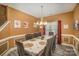 Well-lit dining room featuring a long table, upholstered chairs, and an elegant chandelier fixture at 3846 Bent Creek Sw Dr # 58, Concord, NC 28027