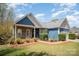 Charming single-story home with blue accents, stone, manicured lawn and an attached two-car garage at 3846 Bent Creek Sw Dr # 58, Concord, NC 28027
