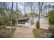 Exterior view of a home with a backyard featuring a covered patio, fire pit, and lush landscaping at 3846 Bent Creek Sw Dr # 58, Concord, NC 28027