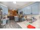 Spacious kitchen featuring blue cabinets, stainless steel appliances, and an open view to the living area at 3846 Bent Creek Sw Dr # 58, Concord, NC 28027