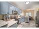 Charming kitchen features stainless appliances, granite counters, and light blue cabinets at 3846 Bent Creek Sw Dr # 58, Concord, NC 28027