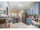 Bright kitchen with blue cabinets, stainless steel appliances, and an open design to the dining area at 3846 Bent Creek Sw Dr # 58, Concord, NC 28027