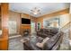 Cozy living room with a fireplace, ceiling fan, plush leather seating, and an open view to the kitchen at 3846 Bent Creek Sw Dr # 58, Concord, NC 28027