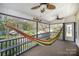 Cozy screened-in porch with a hammock, peaceful views of surrounding trees and nature at 3846 Bent Creek Sw Dr # 58, Concord, NC 28027