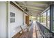 Covered front porch with wooden swing and railings, ideal for enjoying the outdoors at 3846 Bent Creek Sw Dr # 58, Concord, NC 28027
