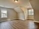 Bright attic with wood-look flooring and recessed lighting at 6008 Grassy Knoll Cir, Matthews, NC 28104