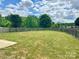 A generously sized, fenced-in backyard features a sprawling lawn and mature trees at 6008 Grassy Knoll Cir, Matthews, NC 28104