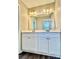 Bathroom with a double vanity, white cabinets, and modern lighting at 6008 Grassy Knoll Cir, Matthews, NC 28104