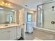 Bright bathroom with double sinks, a walk-in glass shower and contemporary fixtures at 6008 Grassy Knoll Cir, Matthews, NC 28104