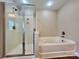 Bright bathroom featuring a glass shower, a bathtub, and contemporary fixtures at 6008 Grassy Knoll Cir, Matthews, NC 28104