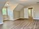 Spacious bedroom features wood flooring, natural light, and convenient access to additional rooms at 6008 Grassy Knoll Cir, Matthews, NC 28104