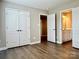 Spacious bedroom with wood-look flooring and a view into the bathroom at 6008 Grassy Knoll Cir, Matthews, NC 28104